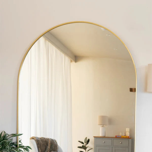 Circular mirror with a thin gold frame. - Horizon and Stone 
